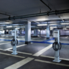 Two EvoCharge mounted on two pedestals in an empty parking garage.